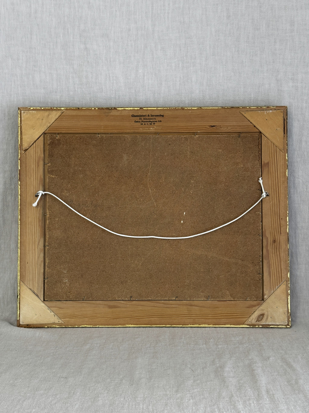 Reverse of the Swedish oil painting showing the pine frame back, hanging cord and Malmo framer's stamp