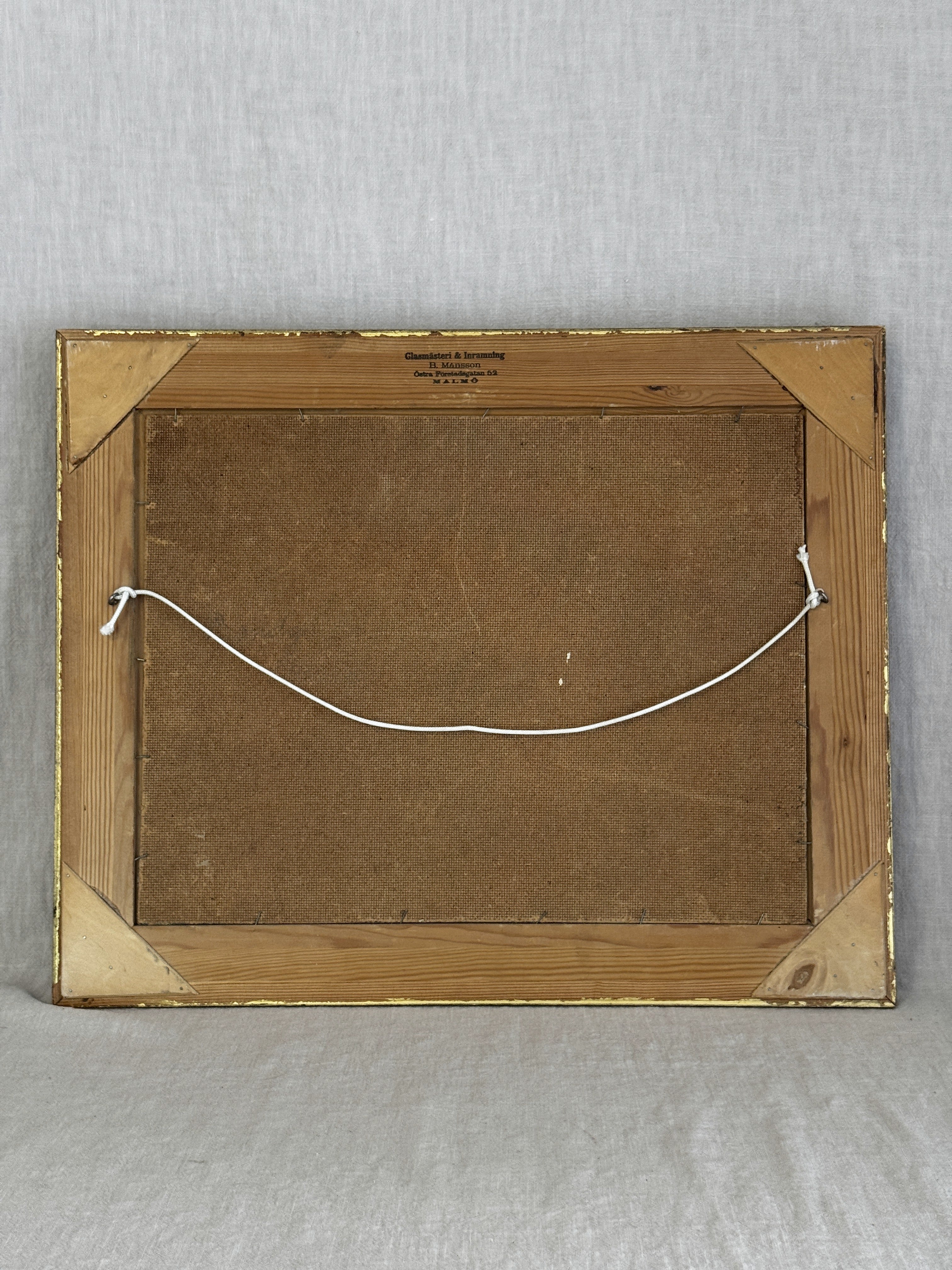 Reverse of the Swedish oil painting showing the pine frame back, hanging cord and Malmo framer's stamp