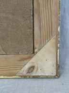 Corner detail of the frame reverse with triangular blocks and worn gilding on the vintage Swedish painting