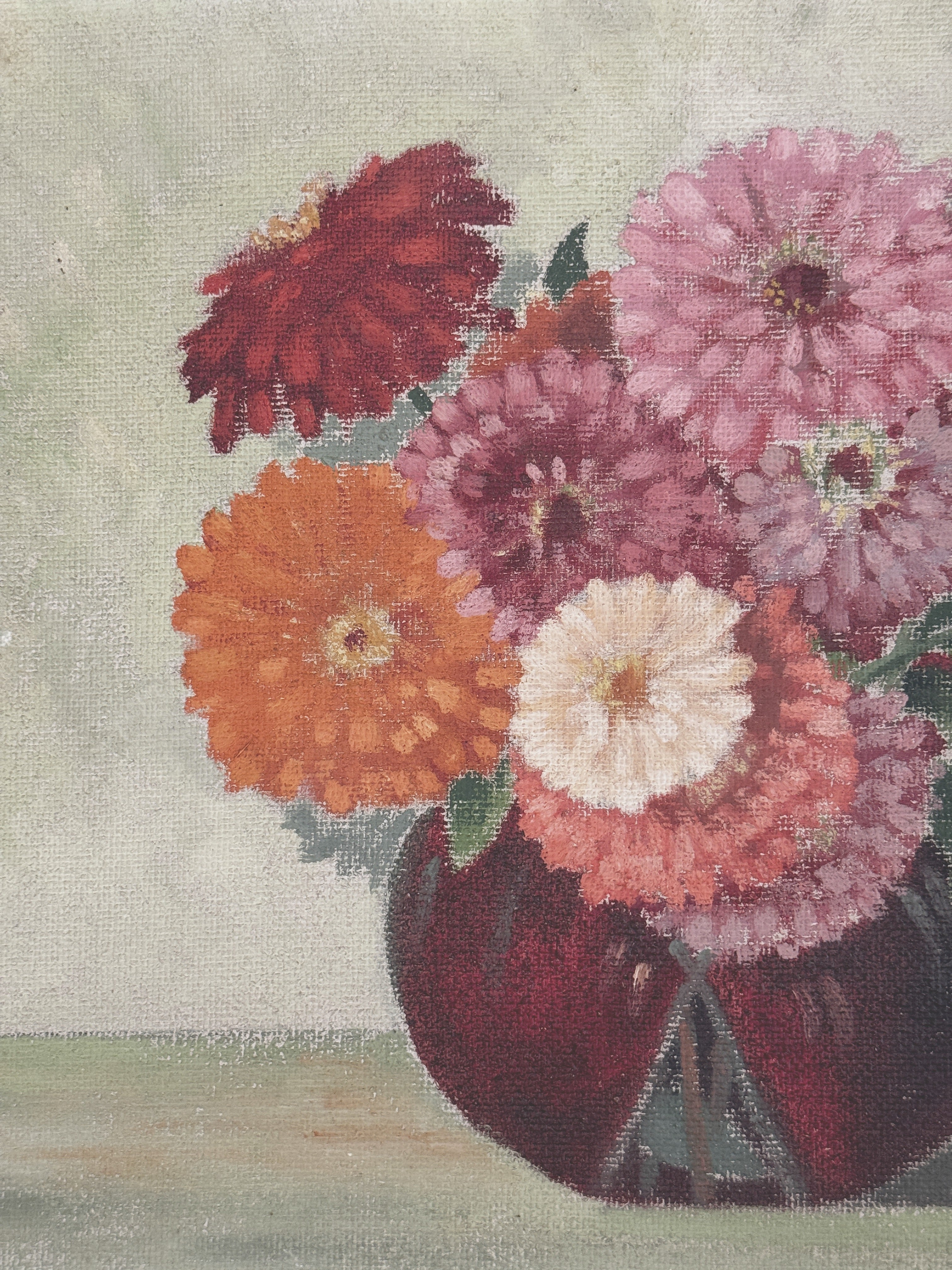 Detail of the orange and white zinnias and the round dark red vase on a green table in the 1946 painting