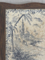 Close-up of the mosque, minaret and palm trees in blue transfer print beside the wooden frame edge