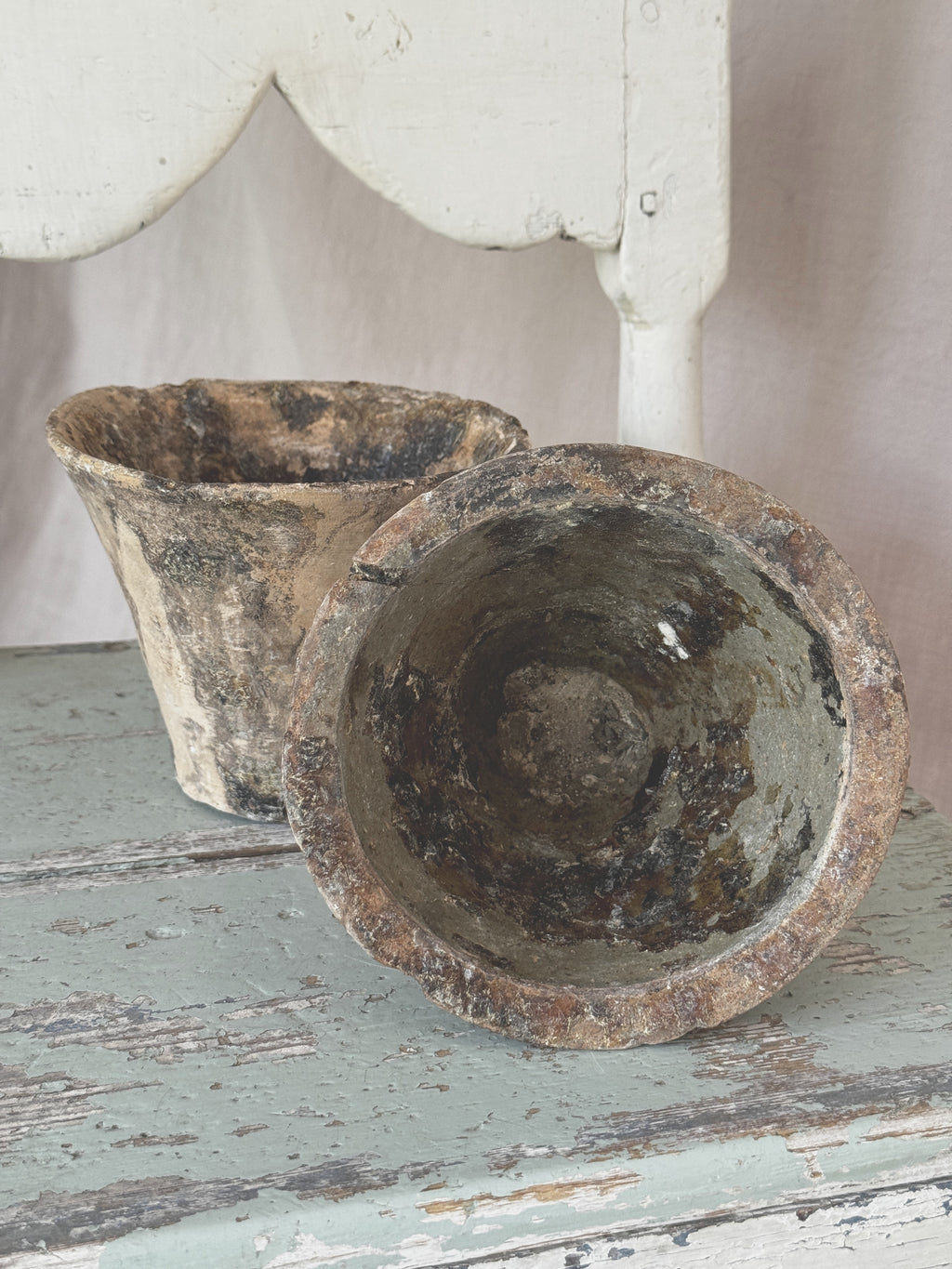 Antique French resin pots in unglazed terracotta, one tipped to show the resin-lined interior