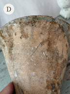 Resin pot D held in the hand, close view of the terracotta surface and rim