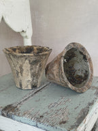Stack of four antique French terracotta resin pots showing their varied colours and patina