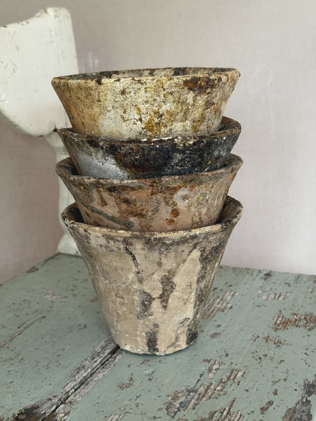 Antique French resin pots arranged together, pale sand, ochre and rust tones in terracotta