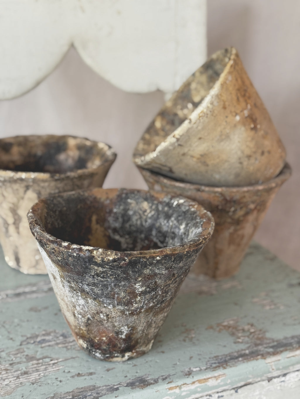 Group of antique terracotta pine sap pots with timeworn resin runs on the outer walls