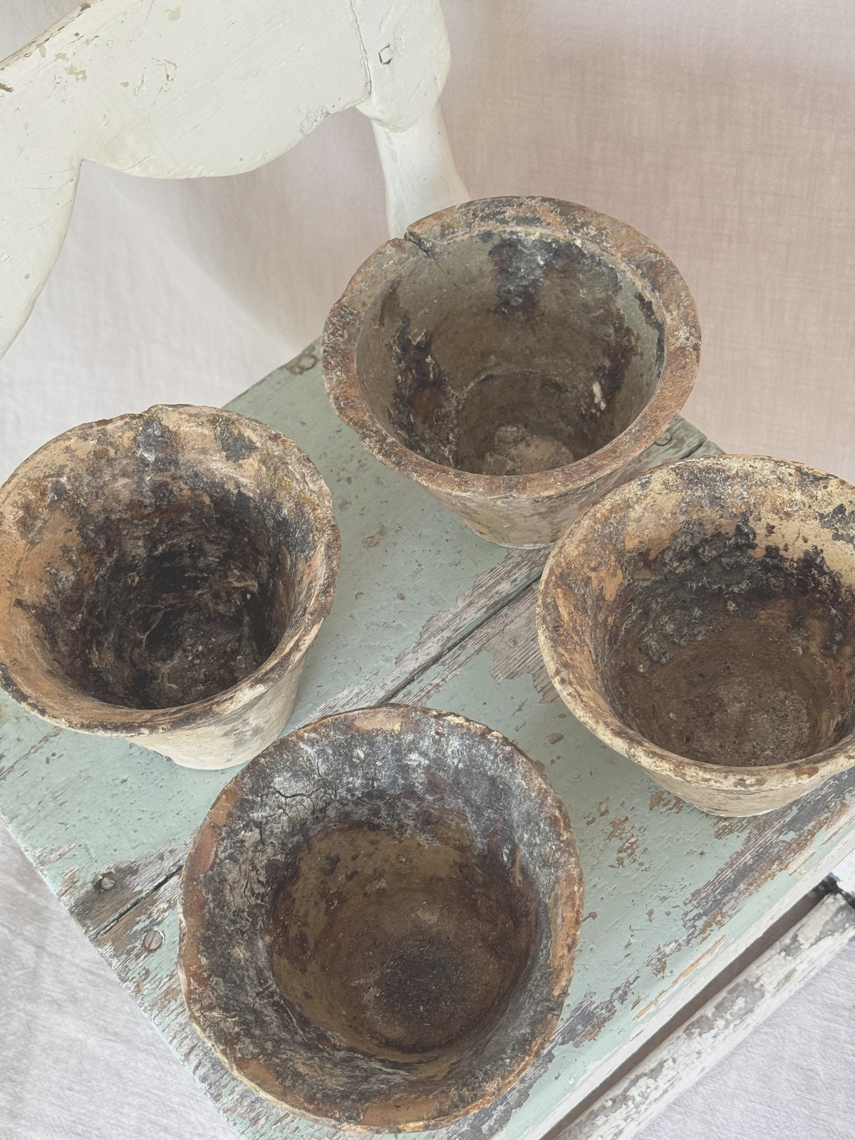 Four antique French resin pots seen from above, showing the resin-coated interiors