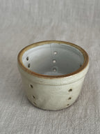 Rolled ochre rim of the larger French cheese mould seen from above