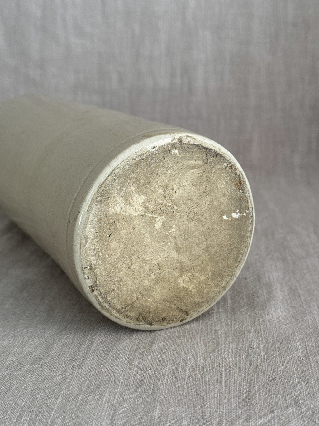Unglazed base of the cream-glazed stoneware bottle