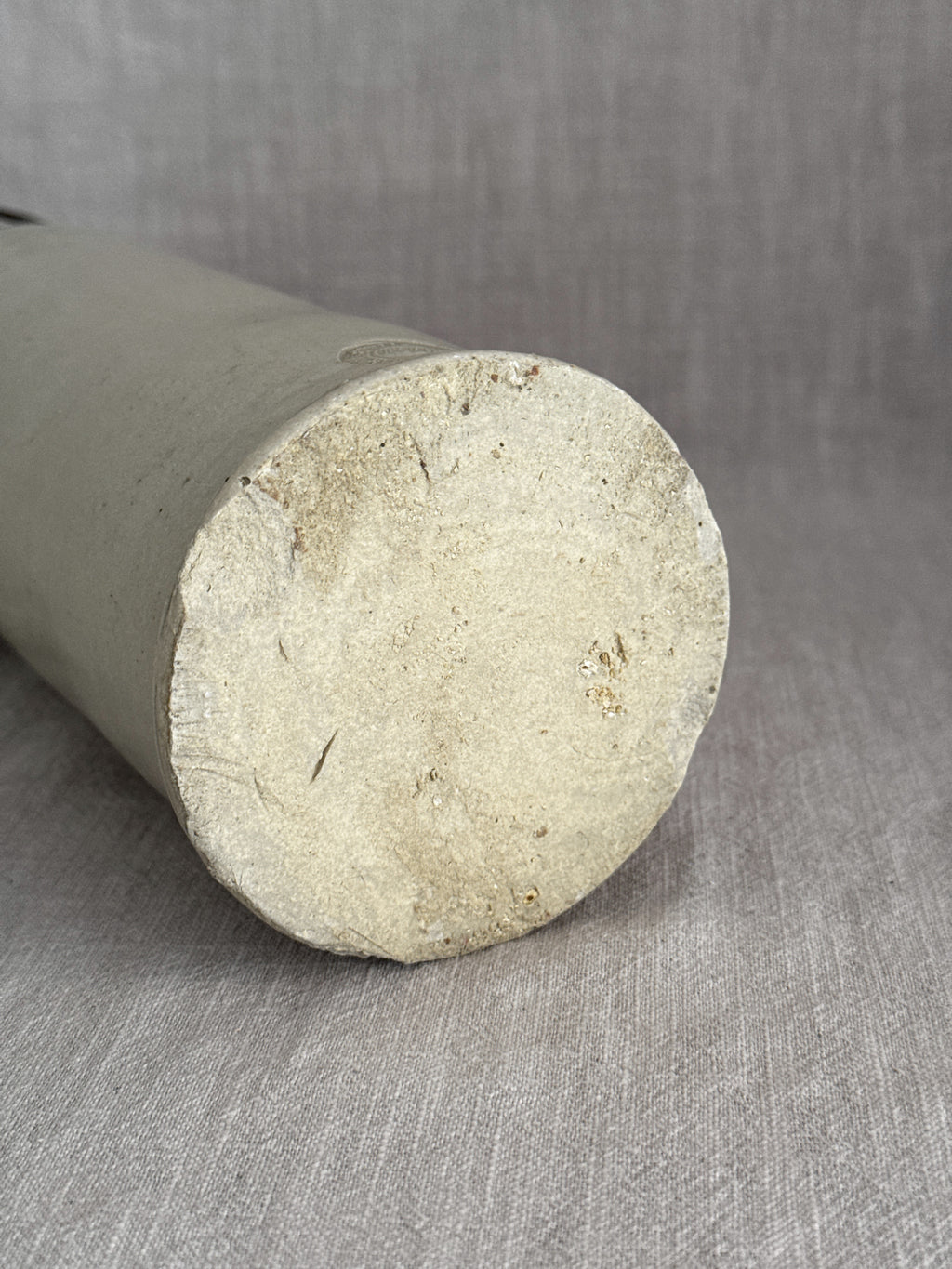 Unglazed base of the tall French grès bottle, laid on its side