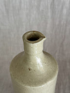 The pouring lip seen from above, with fine crazing visible inside the neck opening