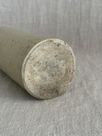 The French stoneware bottle laid on its side, showing the unglazed buff clay base