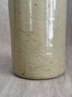 Close view of the lower body, where the fine even crazing across the cream glaze is clearest