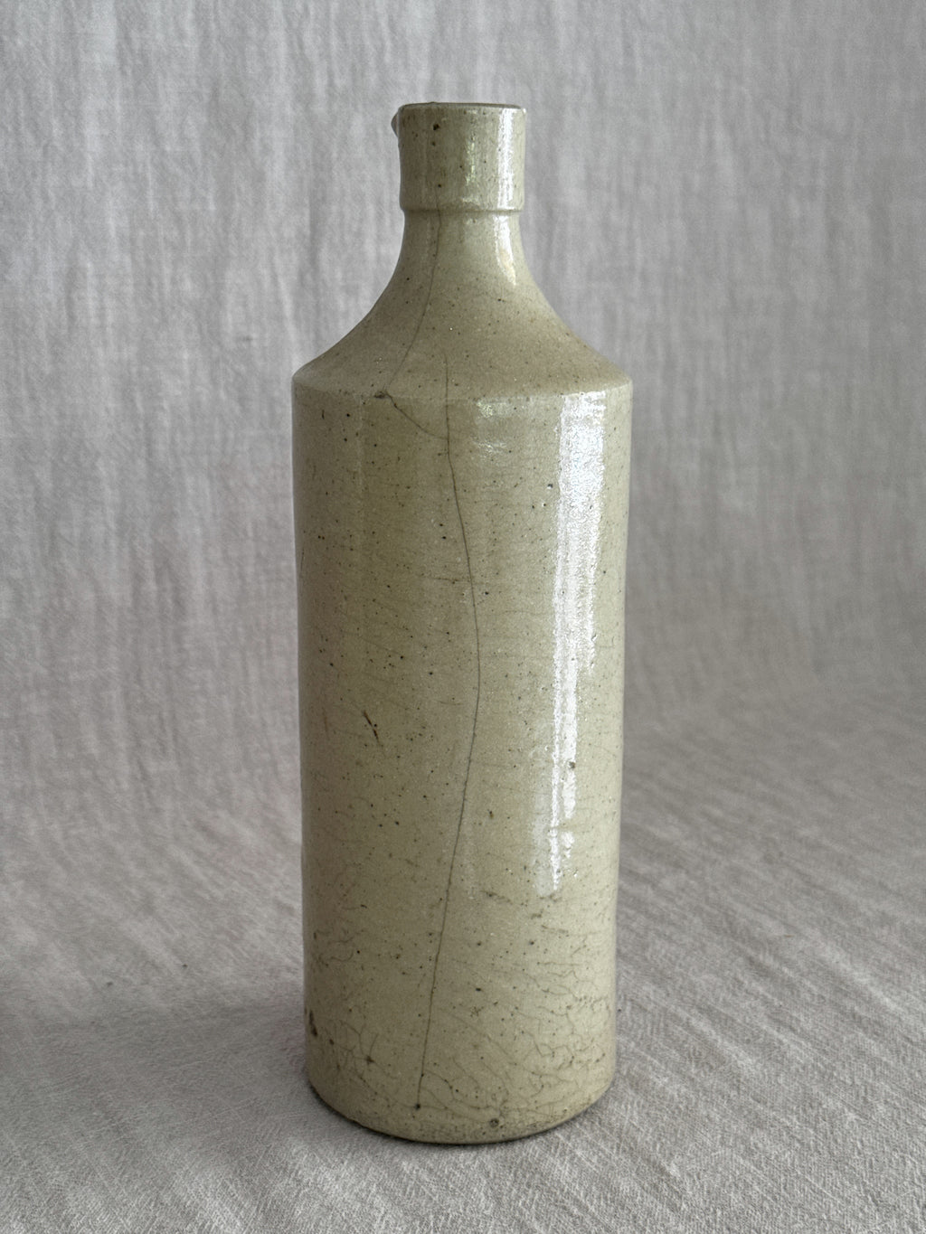 The full bottle photographed from the front, the vertical glaze line visible from shoulder to foot