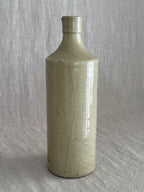 The full bottle photographed from the front, the vertical glaze line visible from shoulder to foot