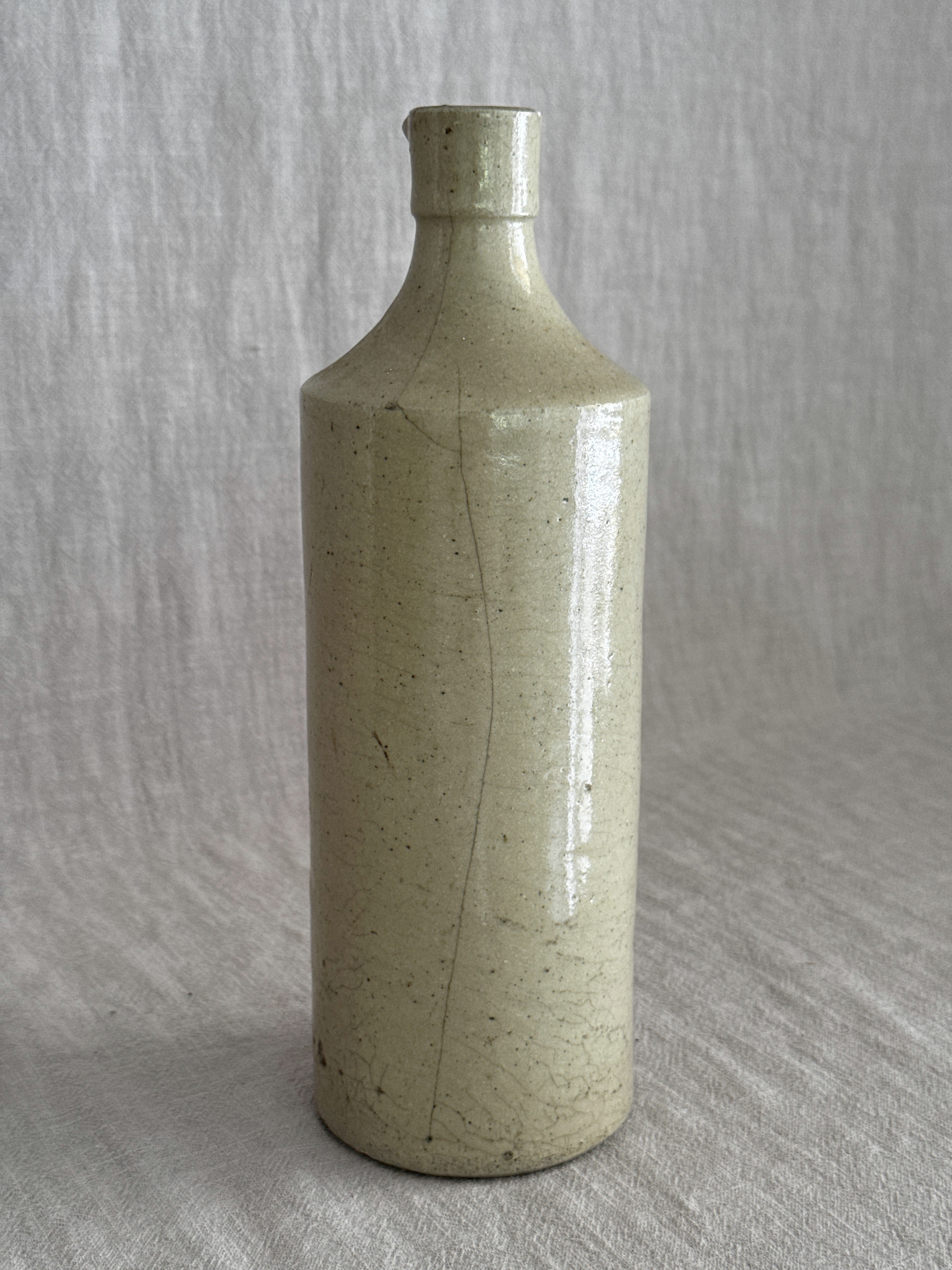 The full bottle photographed from the front, the vertical glaze line visible from shoulder to foot