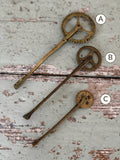 Three antique brass pastry jaggers marked A, B and C