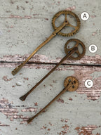 Three antique brass pastry jaggers marked A, B and C