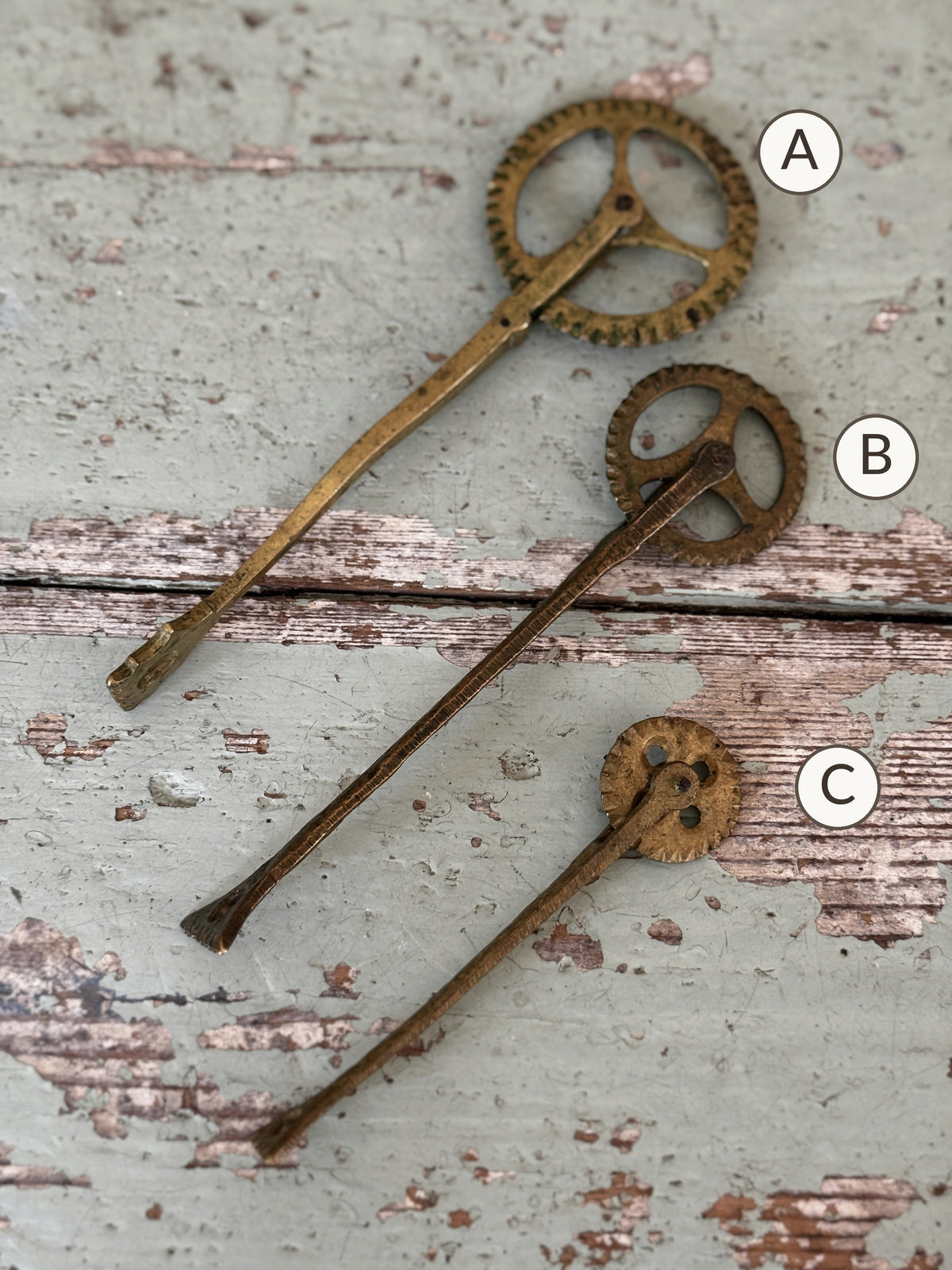Three antique brass pastry jaggers marked A, B and C