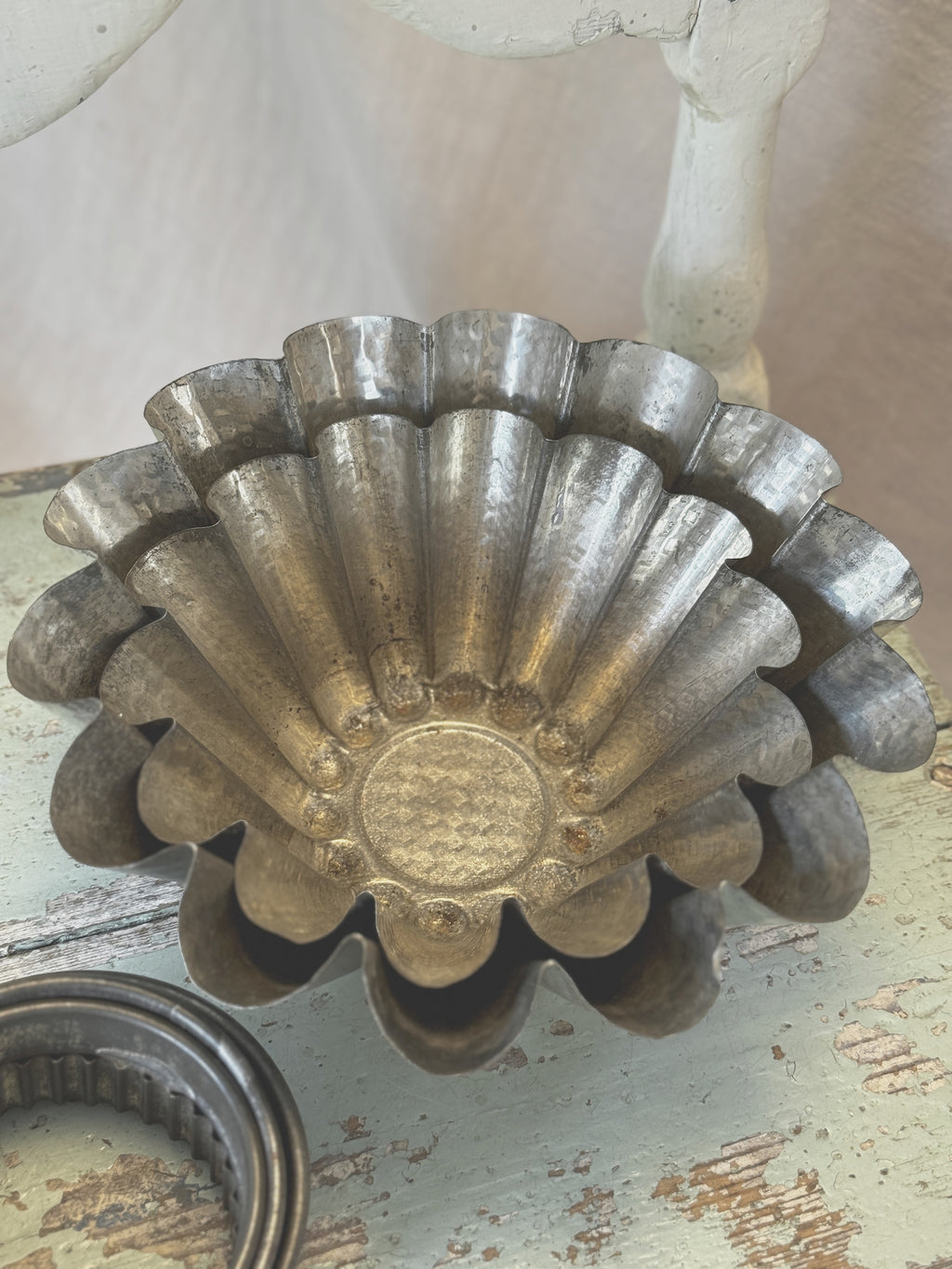 Two nested tin brioche moulds with fluted sides