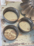 Three graduated fluted tin pastry cutters