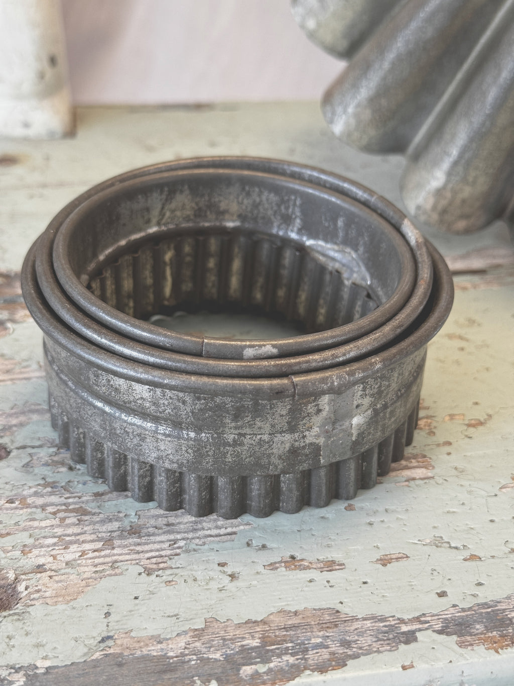 Nested French pastry cutters with tin patina