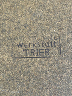 Faded rubber stamp on the fibreboard base reading werkstatt TRIER inside a rectangular frame