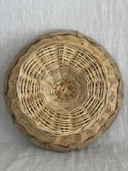 Base of a second willow banneton photographed from below, spiral weave and stapled linen rim