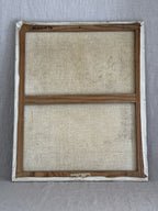 Reverse of the painting showing the light pine French stretcher, the original paper label marked 12 F and an inventory code written in black marker