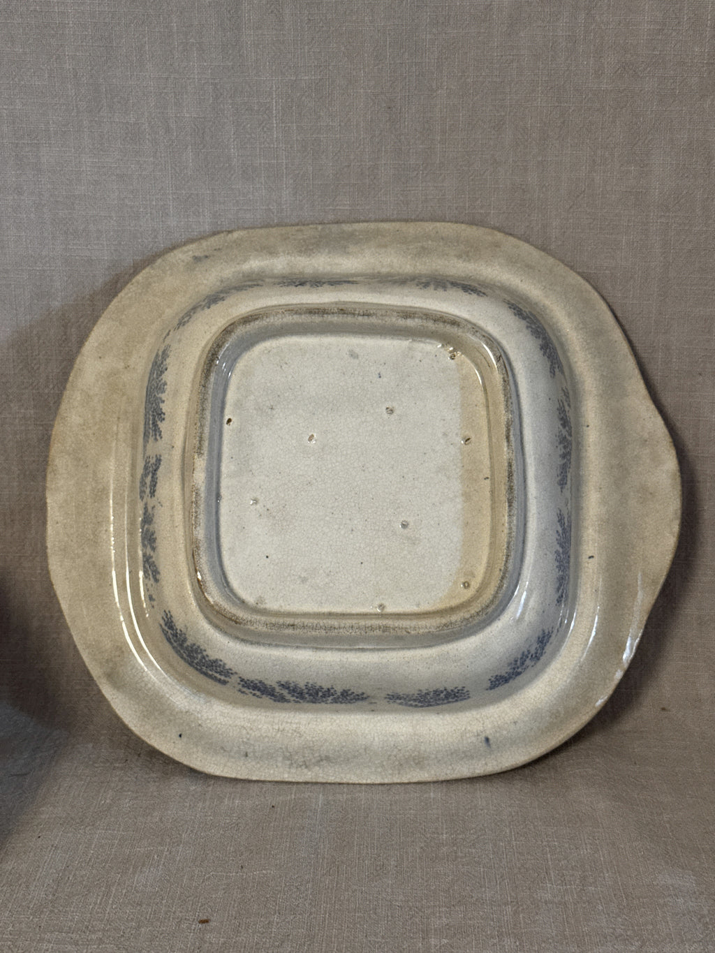 The base of the transferware dish, unmarked, with an unglazed footrim