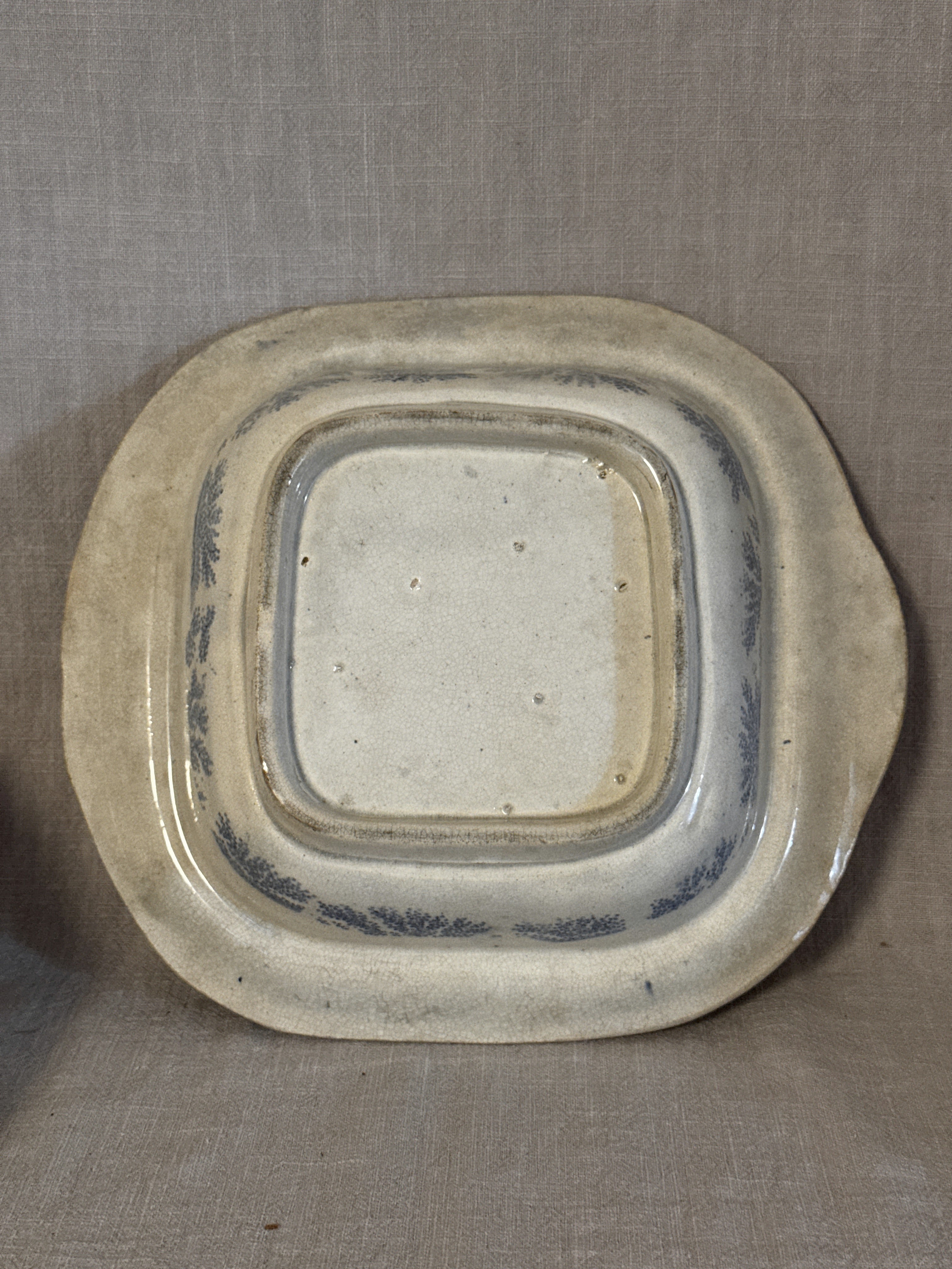 The base of the transferware dish, unmarked, with an unglazed footrim