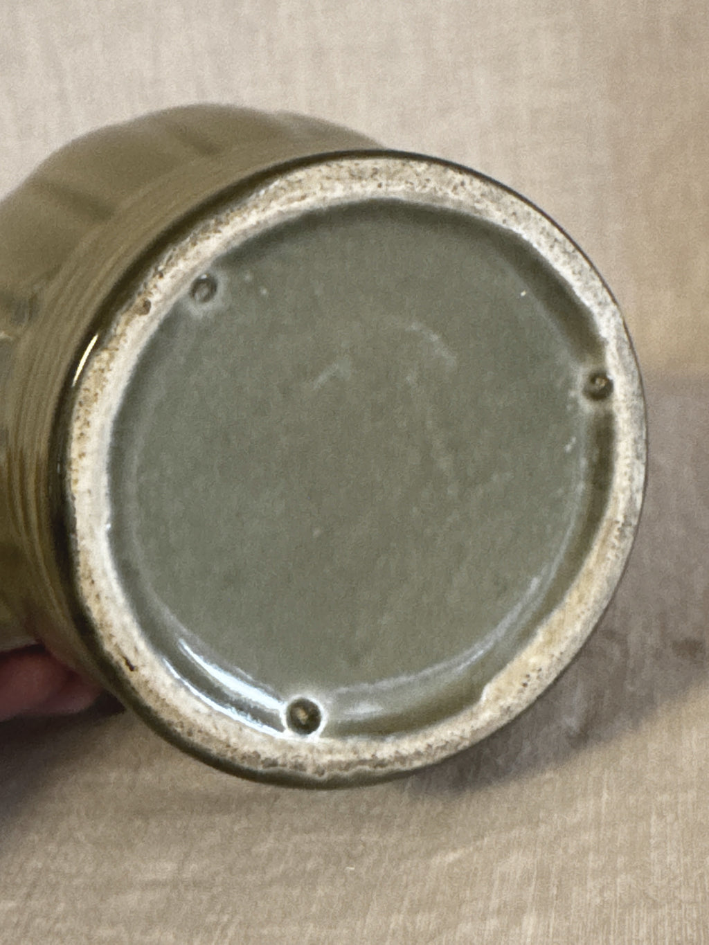 Fully glazed base of the green jug with three kiln stilt marks