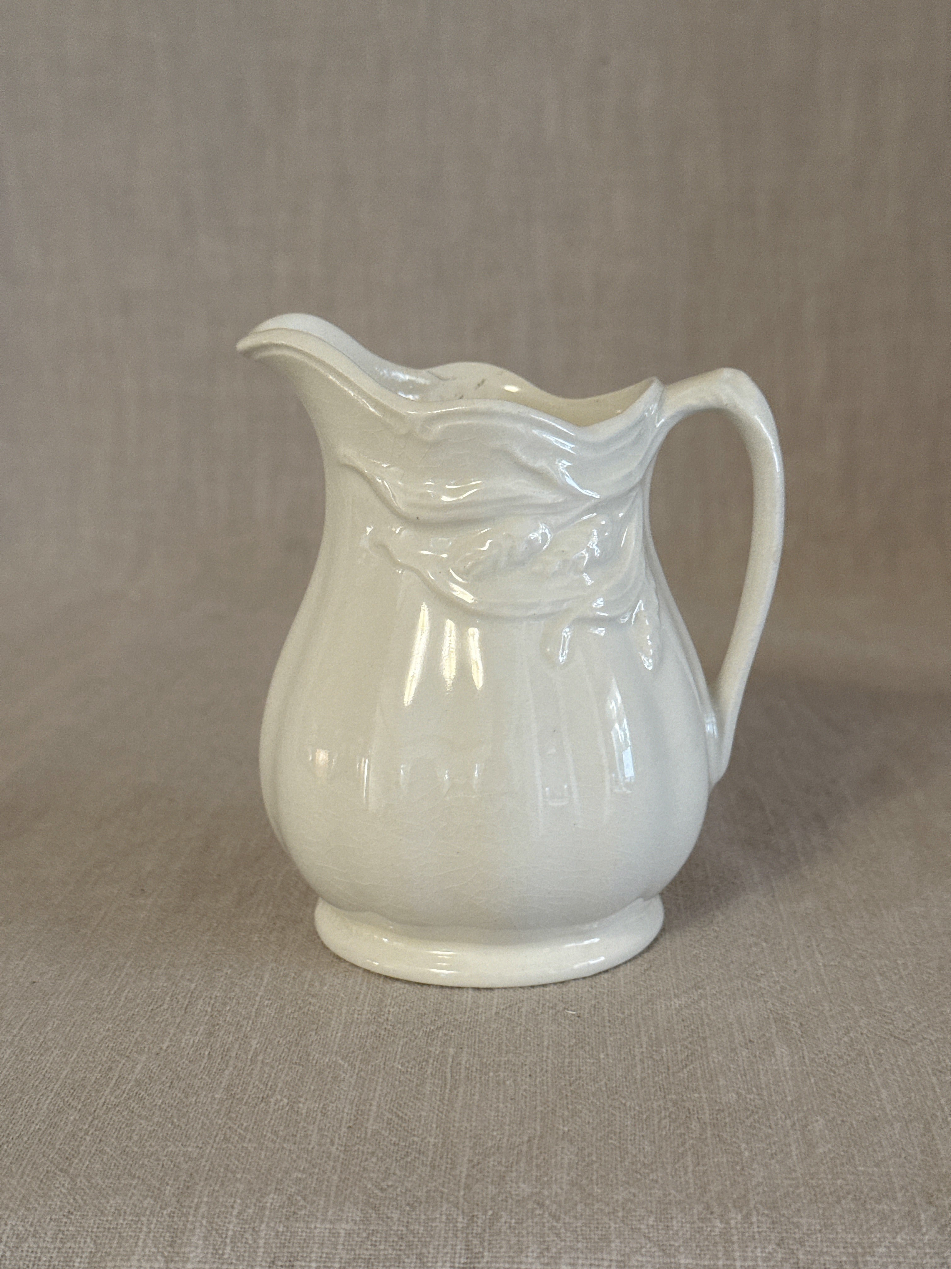 Royal Crownford white ironstone cream jug with drapery moulded rim, one of a pair