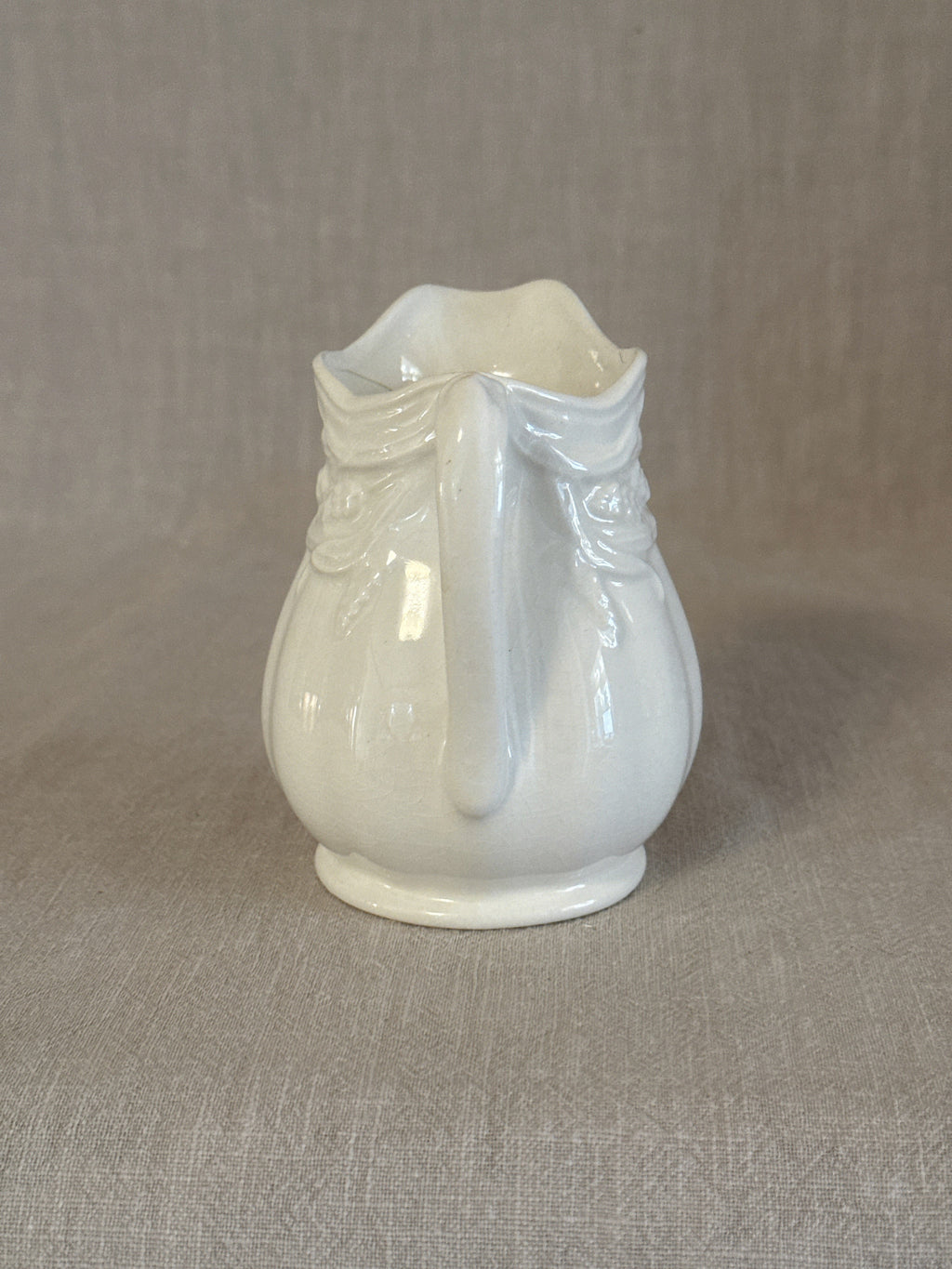 The white ironstone jug showing the moulded drapery detail