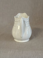 The white ironstone jug showing the moulded drapery detail