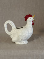 White rooster-form pitcher with red comb, the open beak forming the spout