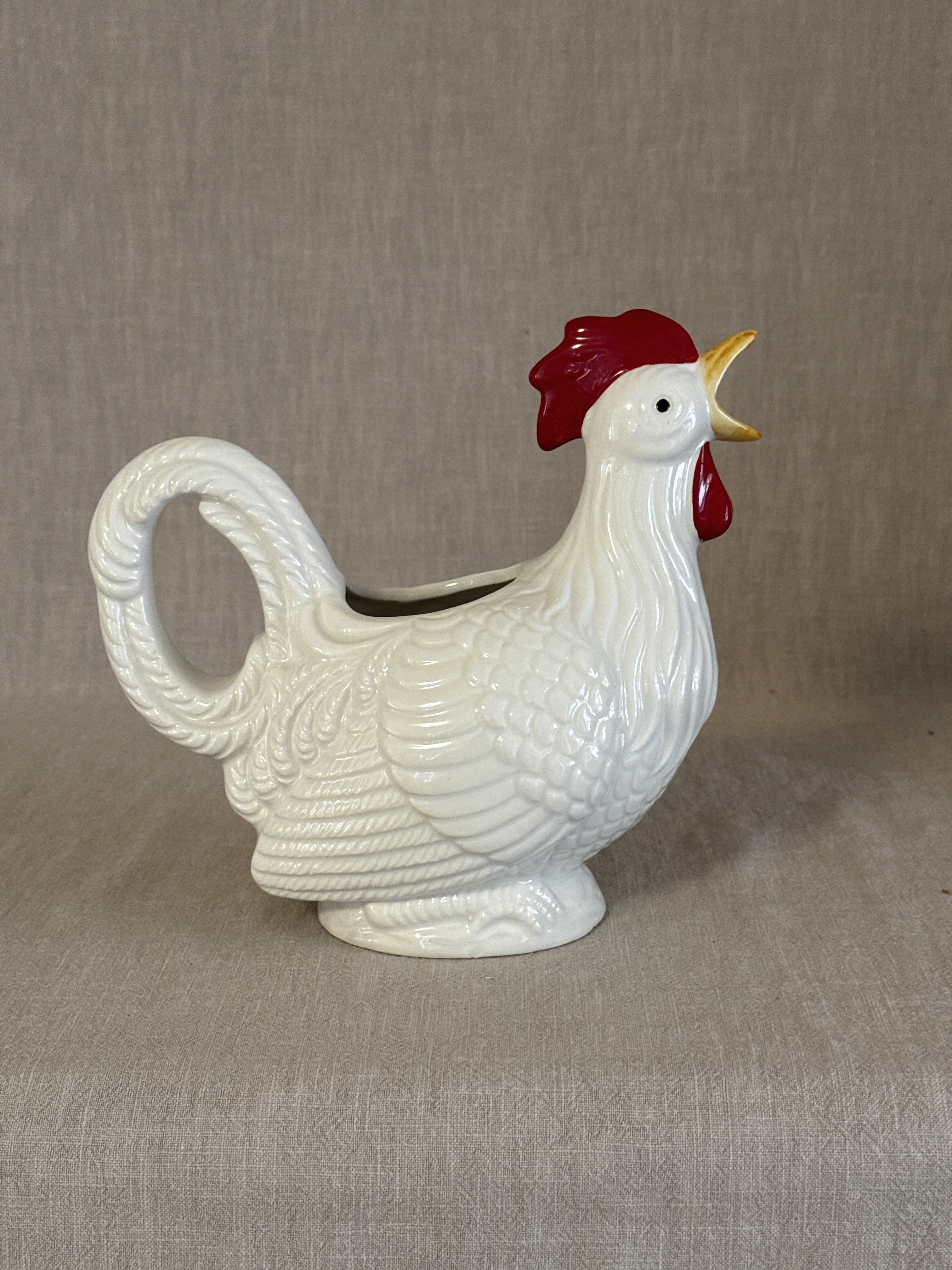 White rooster-form pitcher with red comb, the open beak forming the spout