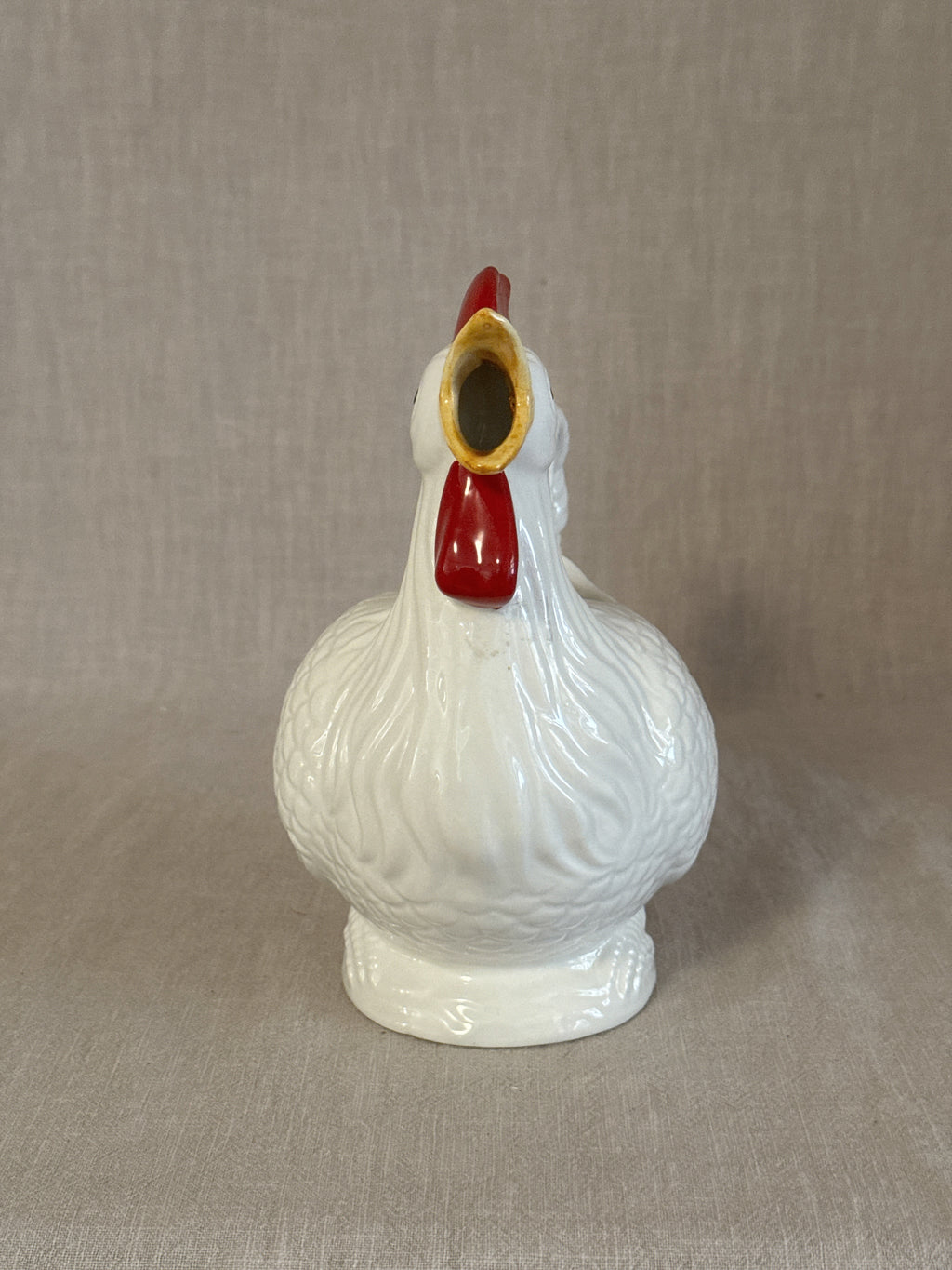 The rooster pitcher seen from the front showing the modelled comb and wattles