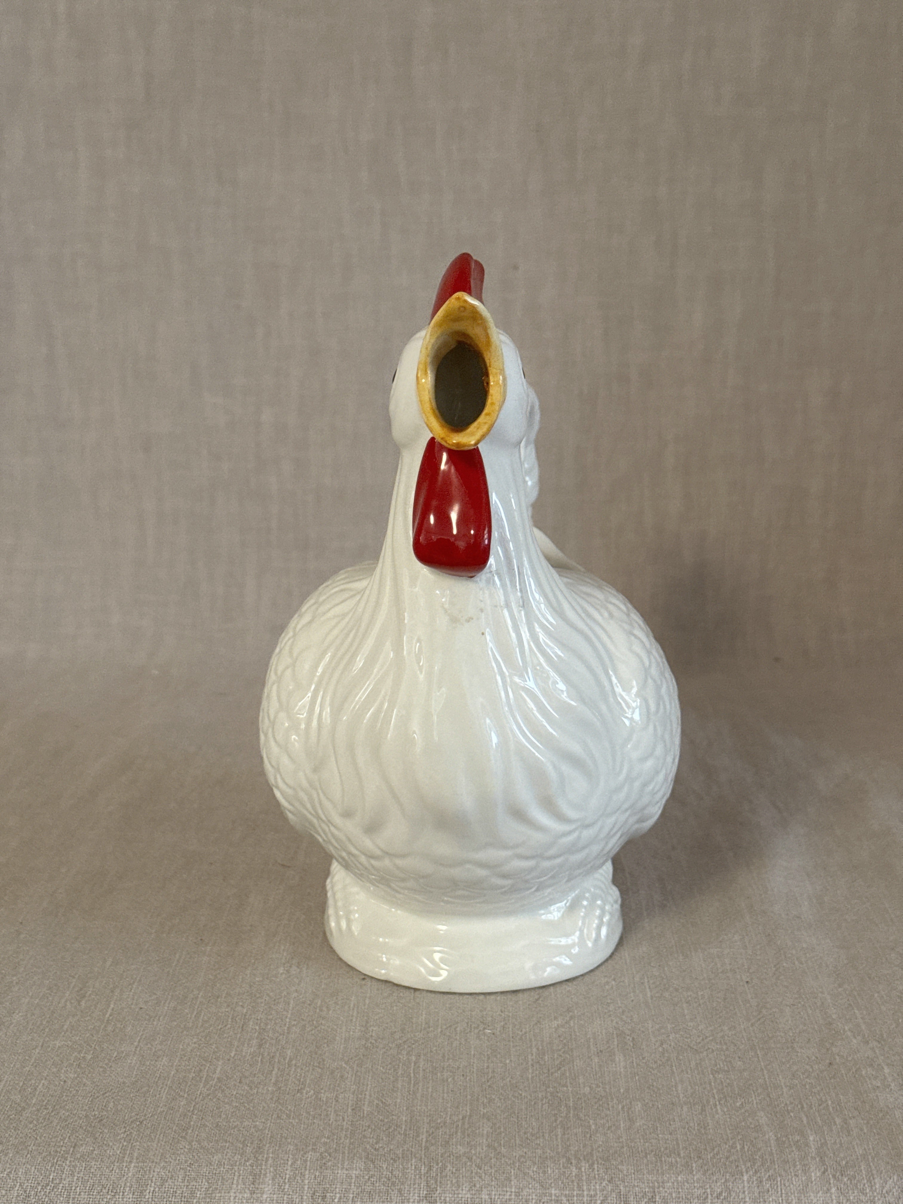 The rooster pitcher seen from the front showing the modelled comb and wattles