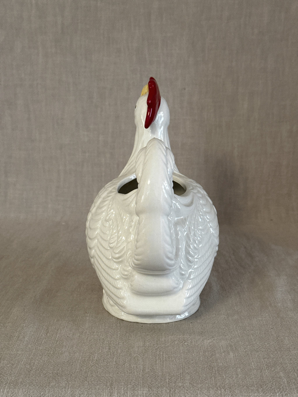 Detail of the rooster head with red comb and yellow beak