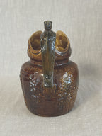 Rear view of the Arthur Wood jug showing the horse head handle from behind
