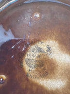 Close-up of the Arthur Wood globe maker's mark on the base of the jug