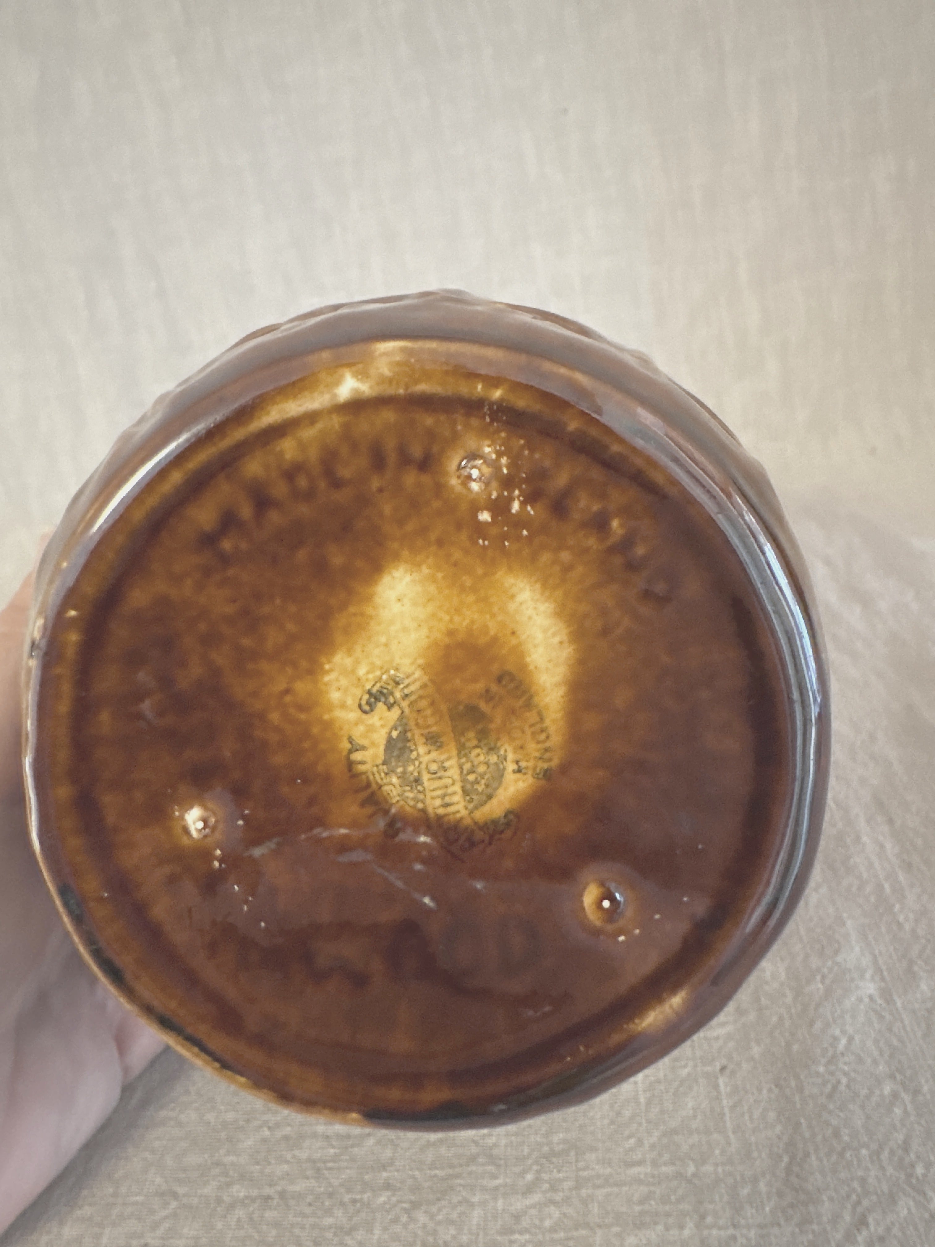 The treacle glazed jug seen from below, showing the marked base and glazed foot