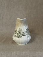 The green transferware jug seen from the front showing the shaped spout