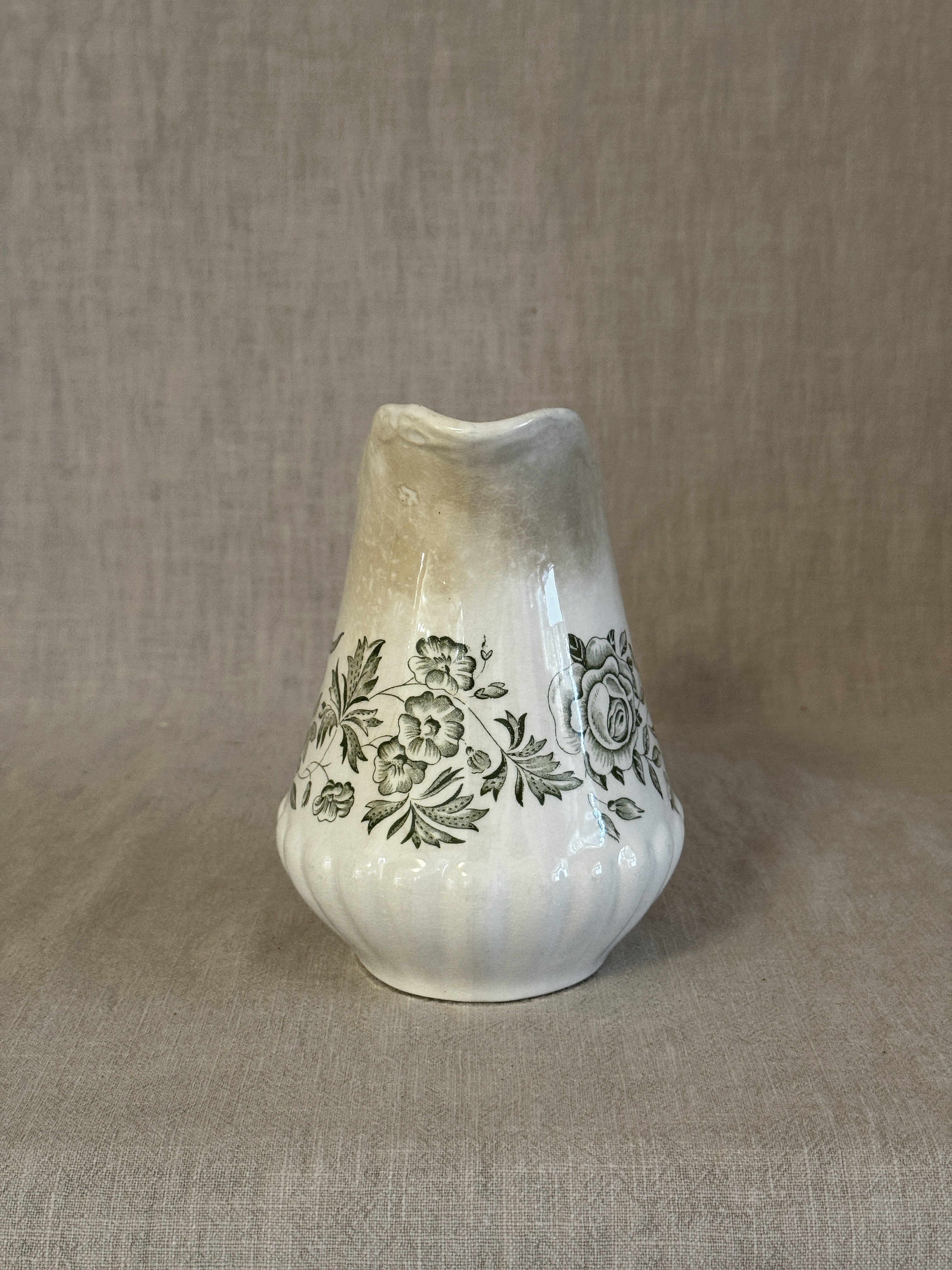 The green transferware jug seen from the front showing the shaped spout