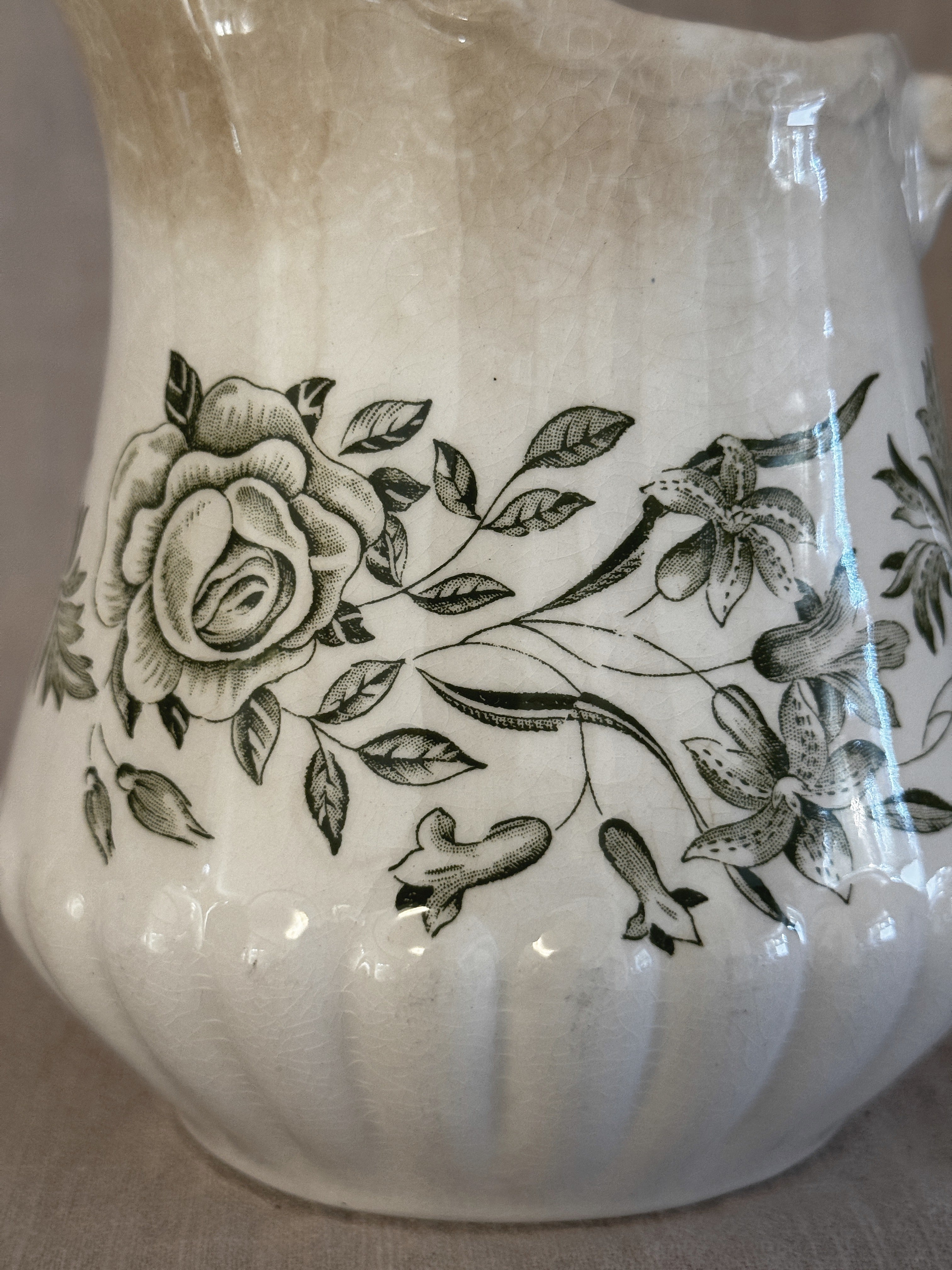 Close-up of the green rose and flower transfer on the jug body