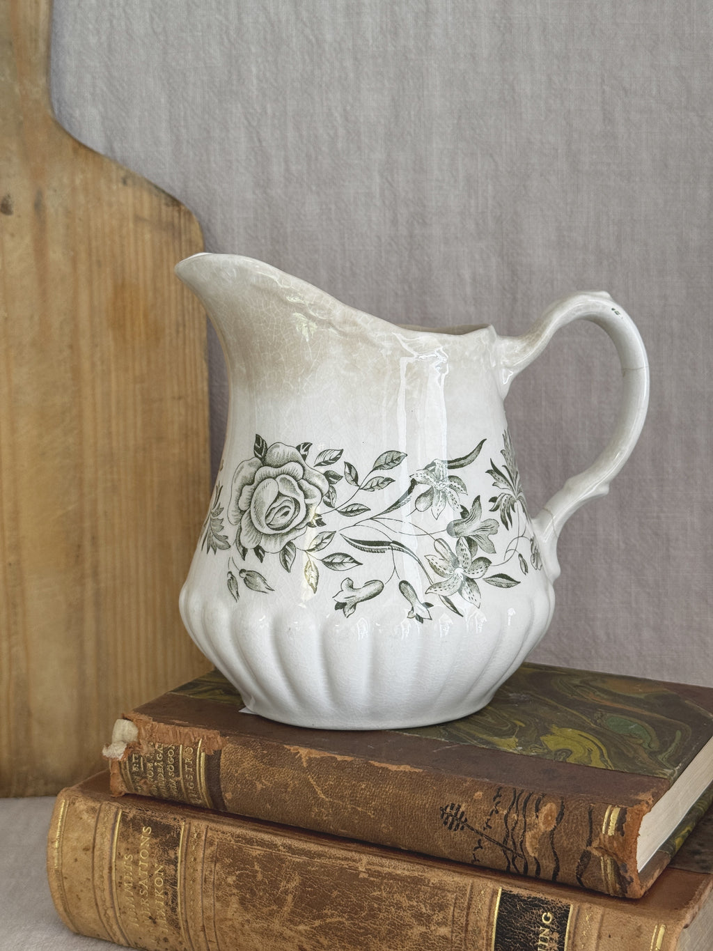 Vintage Grindley Springtime green transferware jug shown against antique books and a bread board for size reference