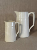 The small white jug shown beside a large jug of the same model, for scale