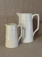 The small white jug shown beside a large jug of the same model, for scale