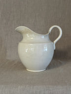 Swedish white earthenware washstand jug with a wide wavy lip and high strap handle